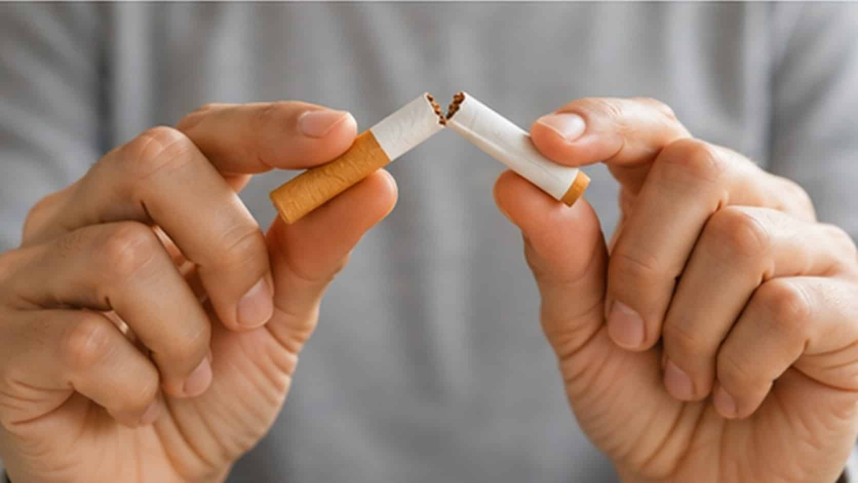 Hands breaking a cigarette as a symbol of quitting smoking